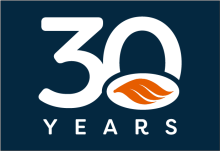 30 years written in white text on a navy background with our orange swoosh in orange overlayed on the bottom half of the 0 in 30. 