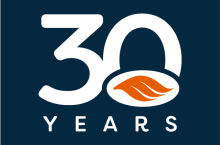 30 years written in white text on a navy background with our orange swoosh in orange overlayed on the bottom half of the 0 in 30. 
